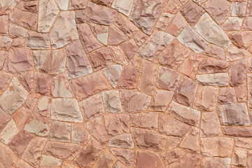 Decorative stone wall in pink tones, for use in background