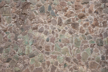 Decorative stone wall in various shades and sober colors, for background use.