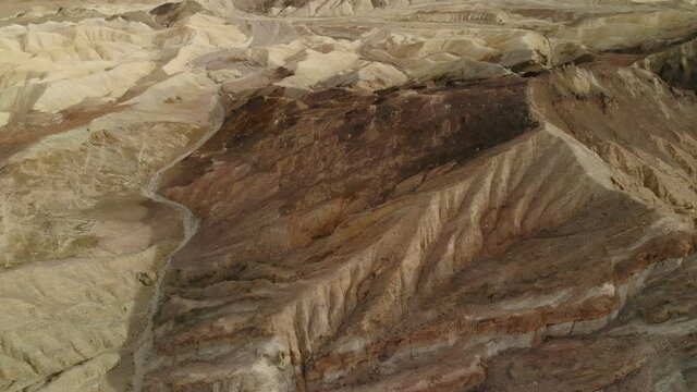 Aerial flyover of colorful sandstone formations in Mojave Desert, California