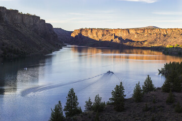 Motor boat on the beautiful lake at sunset. Billy Chinook lake in Oregon, USA, The Cove Palisades...