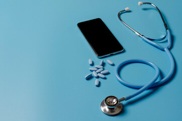 Telemedicine or telehealth, remote doctor video chat consultation concept with smartphone and stethoscope on blue