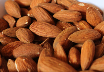 Fresh almond nuts. Cooking, weight loss, and health food concept. Natural lighting.

