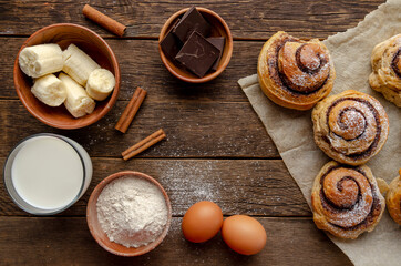 ingredients for cooking buns and ready bans made from banana dough with chocolate and cinnamon. Delicious