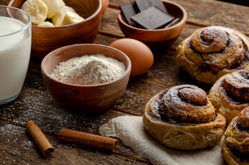ingredients for cooking buns and ready bans made from banana dough with chocolate and cinnamon. Delicious
