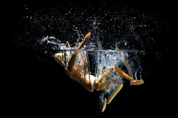 Wooden stick figure falling in water splashing