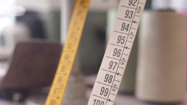 yellow white  flexible ruler tape measure backround out of focus
