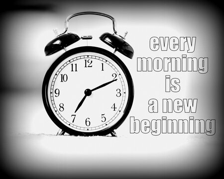 Every morning is a new beginning phrase on background with black vintage alarm clock. Bright bokeh background with copy space.