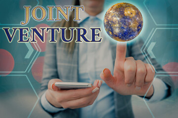 Handwriting text Joint Venture. Conceptual photo business partnership invested jointly by two or more companies Elements of this image furnished by NASA © Zofia