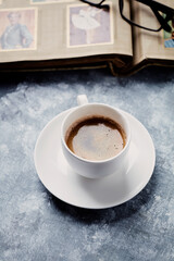 Cup of coffee on rustic wooden background.