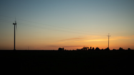 Fototapeta na wymiar Wind generator at sunset on a warm day