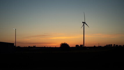 Obraz premium Wind generator at sunset on a warm day