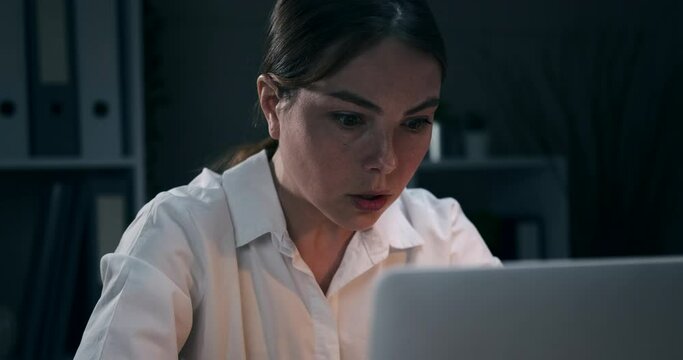 Worried businesswoman regretting her wrongdoing and miscalculation late night at office