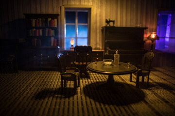 A realistic dollhouse living room with furniture and window at night. Artwork table decoration with handmade realistic dollhouse.