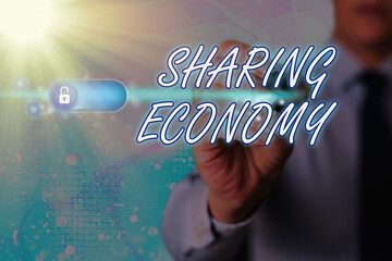 Writing note showing Sharing Economy. Business concept for a system where assets are shared...