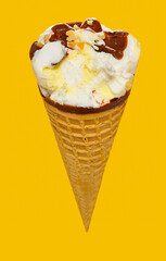 angle view fresh vanilla flaovr ice cream cone with chocolate with a bite on a yellow background