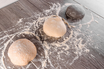 Dough ball with flour. Cooking pizza with italian white dough. Food blanks in restaurant.