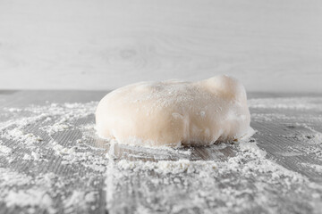 Wheat dough ball with flour. Cooking pizza with italian white dough. Food blanks in restaurant.