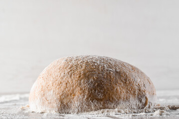 Wheat dough ball with flour. Cooking pizza with italian white dough. Food blanks in restaurant.