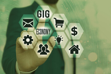 Writing note showing Gig Economy. Business concept for a market system distinguished by shortterm...