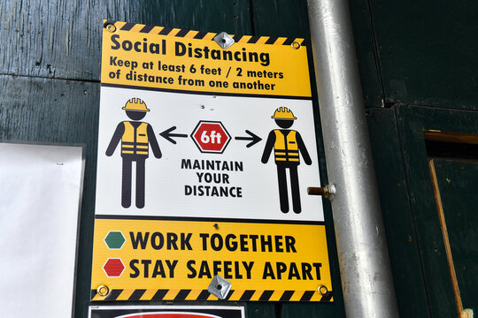 Signs advocating social distancing to help the spread of coronavirus COVID-19 - Powered by Adobe