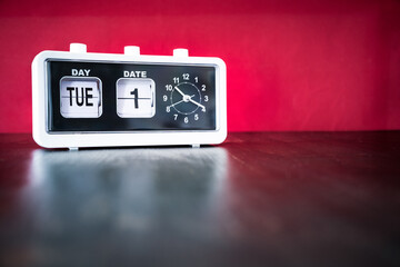 Tuesday 1st, First Tuesday of the month - white vintage alarm clock with set date and time
