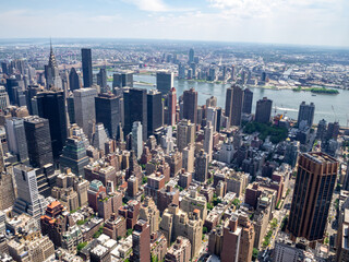 Fototapeta na wymiar Manhattan midtown buildings and streets, East River and Queens viewed from above