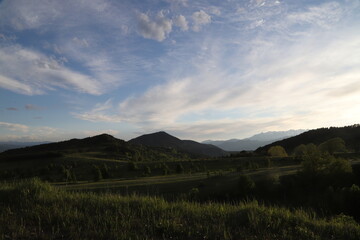 Obraz premium Scenic panoramic landscape of a picturesque green mountain valley in spring. Historic village with blossoming trees and traditional houses.Savsat/ARTVİN/TURKEY