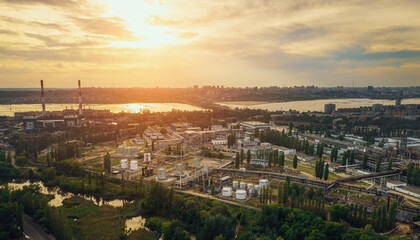 Fototapeta na wymiar Sunset over European city industrial zone with factories, aerial panorama.