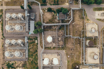 Chemical tanks storages in petrochemical industrial factory, aerial top view from drone.