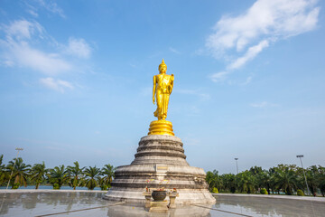 Fototapeta na wymiar Outdoor golden standing buddha statue in thailand 