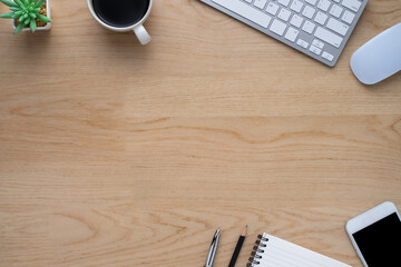 Workspace in office with wood table. Top view from above of keyboard with notebook and coffee. Desk for modern creative work of designer. Flat lay with blank copy space. Business and finance concept.