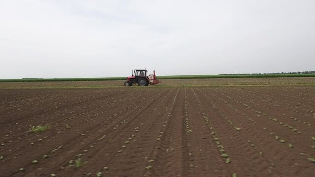 Farmer In Tractor Driving To The Field On A Cloudy Day
