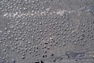 fresh asphalt in drops of water, from top to bottom, flat lay, dark mysterious wallpaper, background
