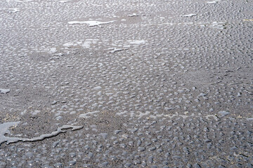 fresh black wet asphalt in drops of water
