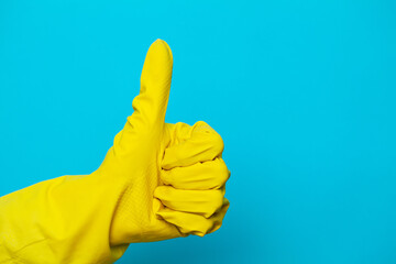 Hand in a yellow glove for cleaning