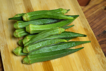 Lady Fingers or Okra Vegetable Over Wooden Table Background