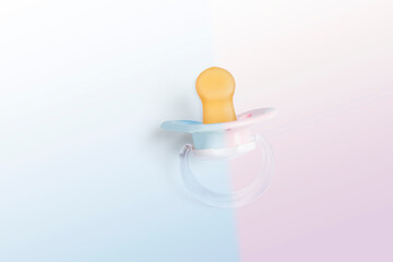 half pink and half blue pacifier. concept for parents expecting a baby and they don't know its gender