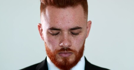 Pensive redhair man closin eyes in contemplation and meditation. executive business guy thinking