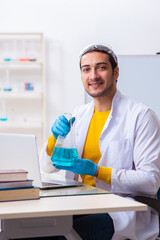 Young male chemist student preparing for exam