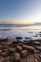 Water flowing through the rocks in the coastline.