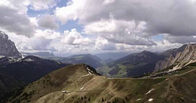 Meadows high in the mountains above Val Gardena. Aerial in the Dolomites above Selva Val Gardena in the background