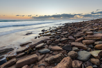 Wave water around the rocky coastline in the morning.