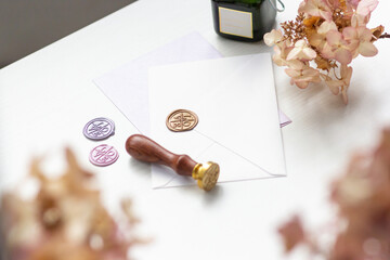 White table with a wax seal and envelopes