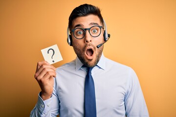 Business operator man with customer service headset from call center showing question mark scared in shock with a surprise face, afraid and excited with fear expression