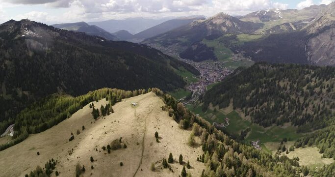 Famous tourist destination in the Alps. Aerial of Selva Val Gardena in Dolomites. Meadows in the sun above Wolkenstein