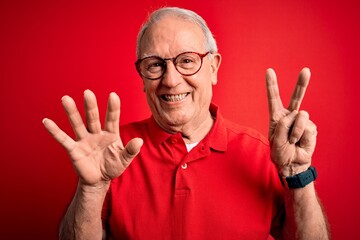 Grey haired senior man wearing glasses and casual t-shirt over red background showing and pointing...
