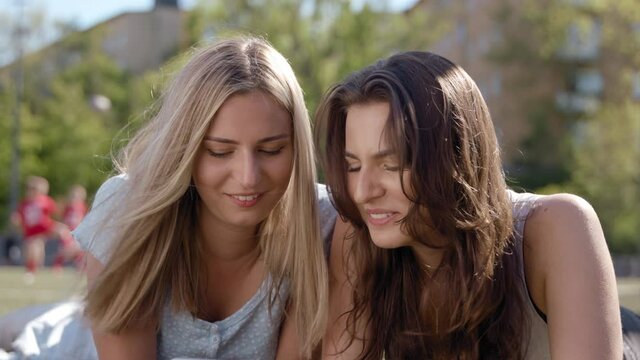 Two teenage girls watching funny videos on TikTok.