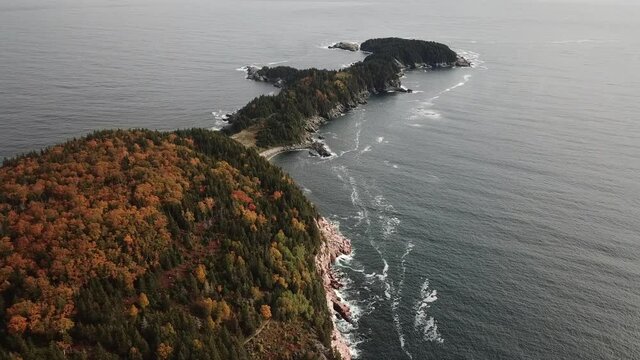 Stunning views of the Atlantic Ocean along the coasts of Cape Breton along the Cabot Trails, Nova Scotia during Autumn. Fall foliage  with multi colored deciduous trees Middlehead Trail.	