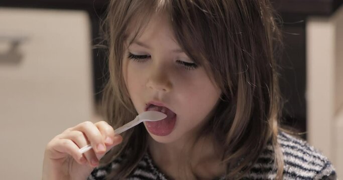 Cute little girl eating ice cream