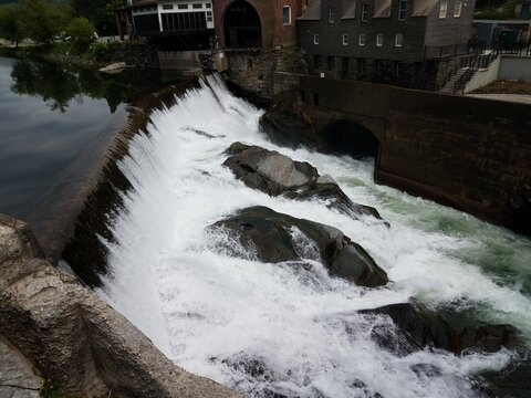 Waterfall Or Rapids And Rocks And Building